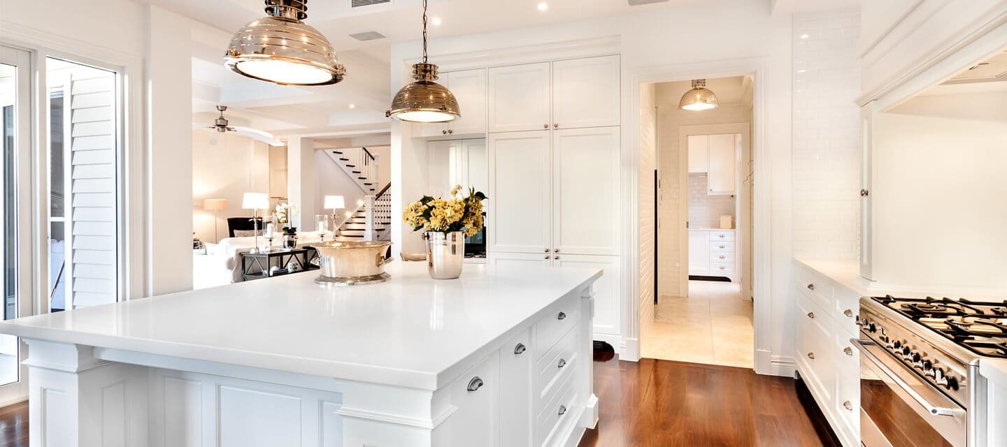 Professional cleaner wiping down a spotless kitchen counter in a modern home